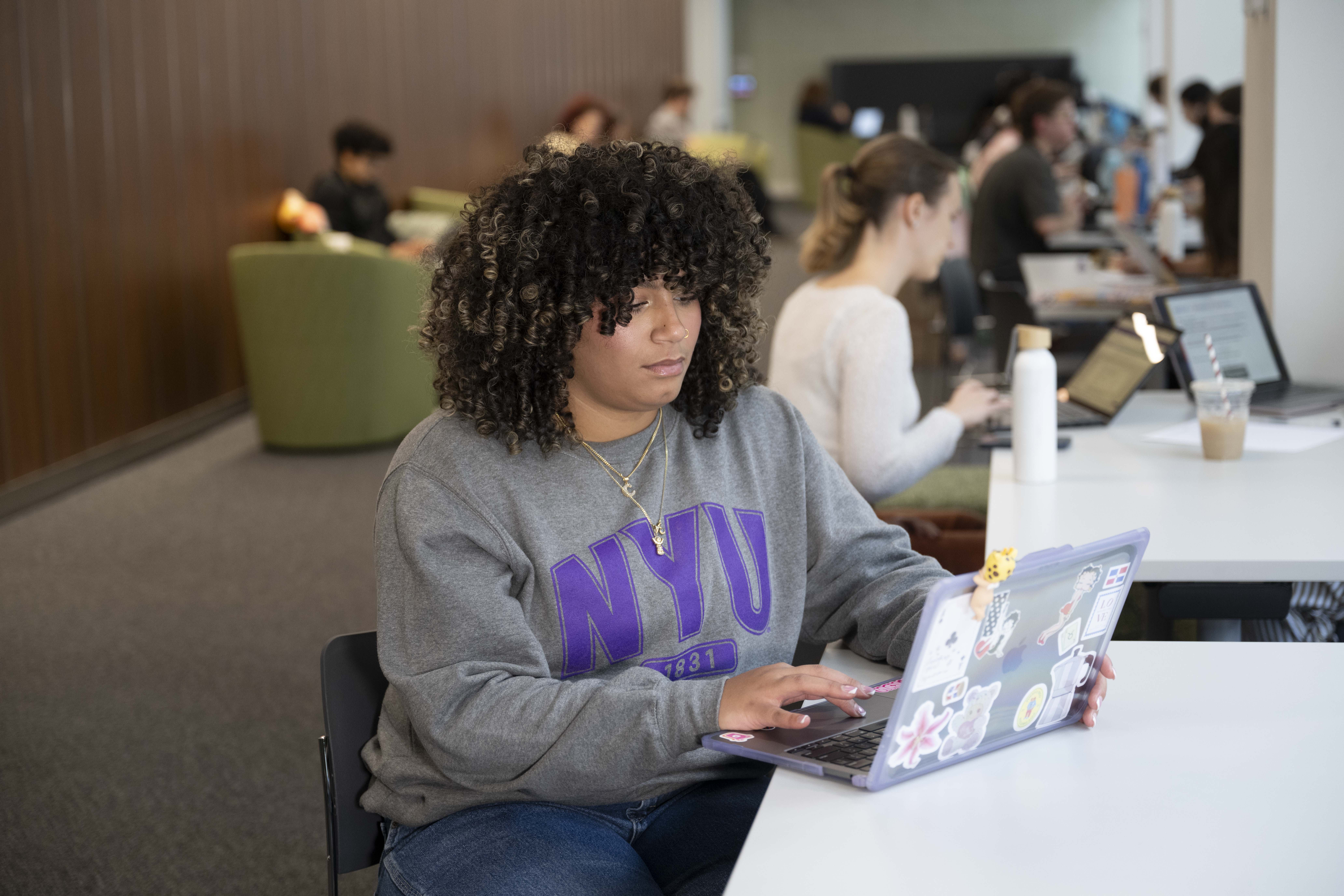 student sitting with a laptop